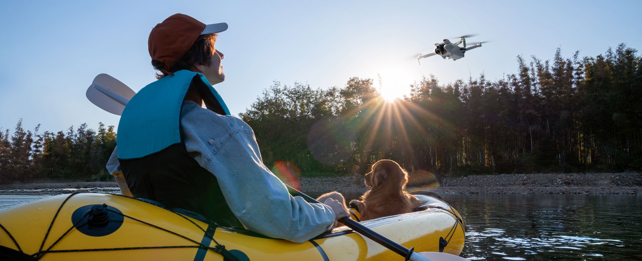 DJI Mini 3 in flight over a lake with person and dog in a boat