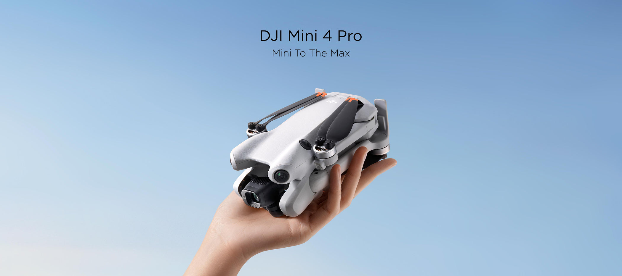 A hand holding a folded DJI Mini 4 Pro with a blue background, text above it says 