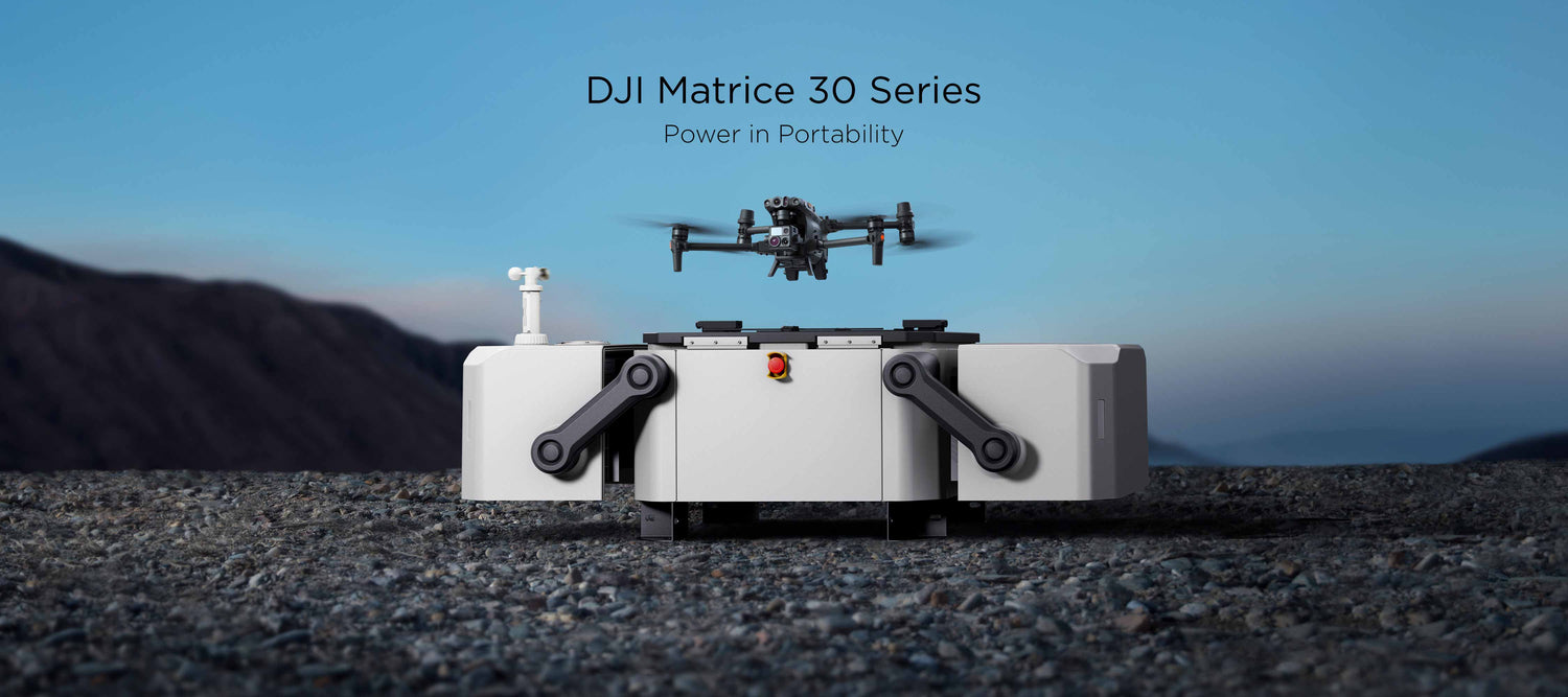 A DJI Matrice 30 series launches from a DJI Dock resting on rocky terrain during a bright, sunny day.