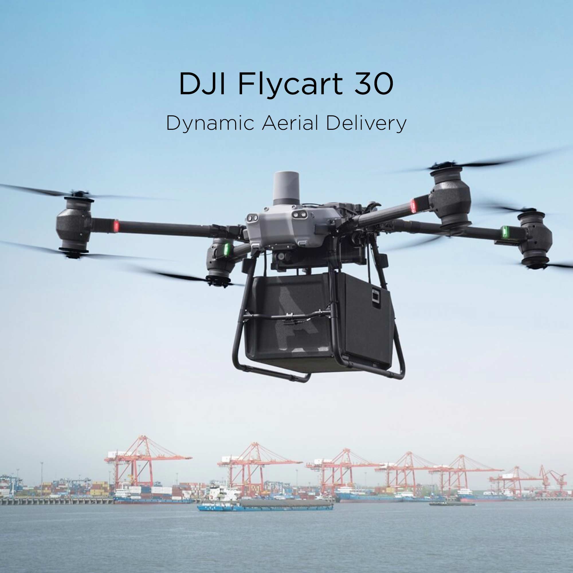 A DJI Flycart 30 transports a large container while cargo ships sail in the background.