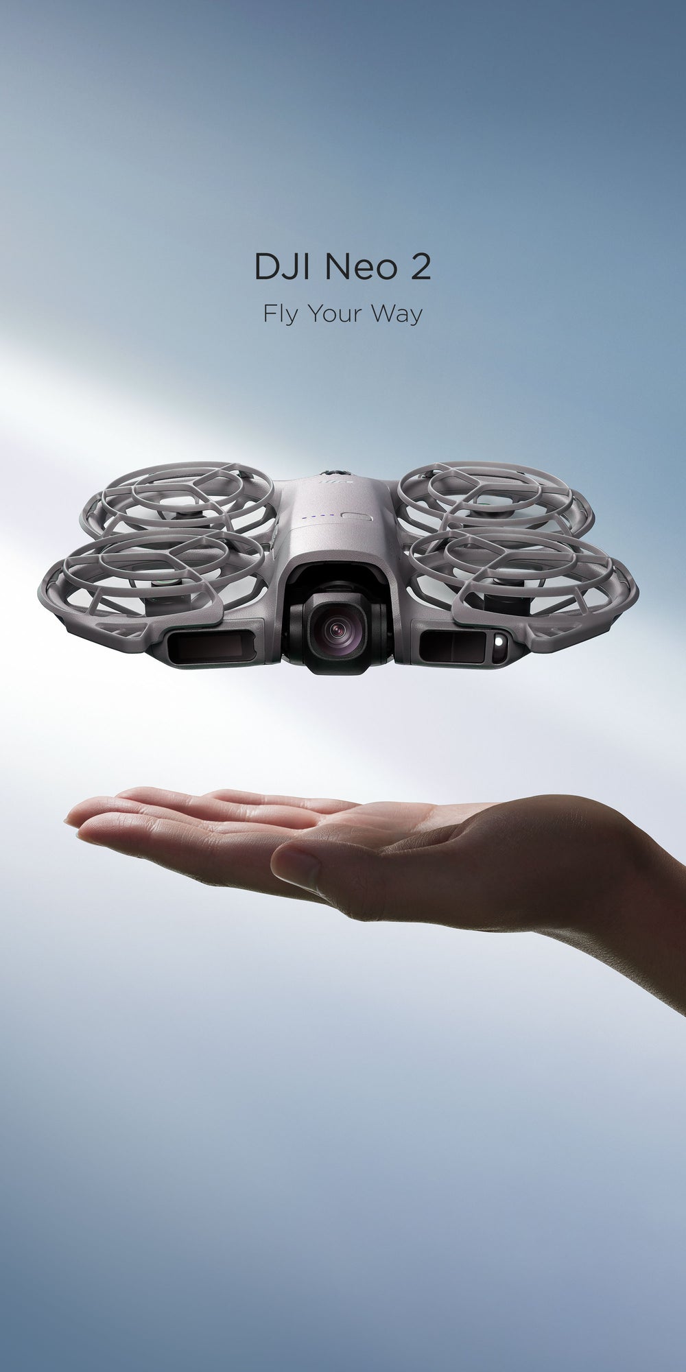 A DJI Neo 2 hovers over an open palm with a blue background. Text above says "DJI Neo 2, Fly Your Way"