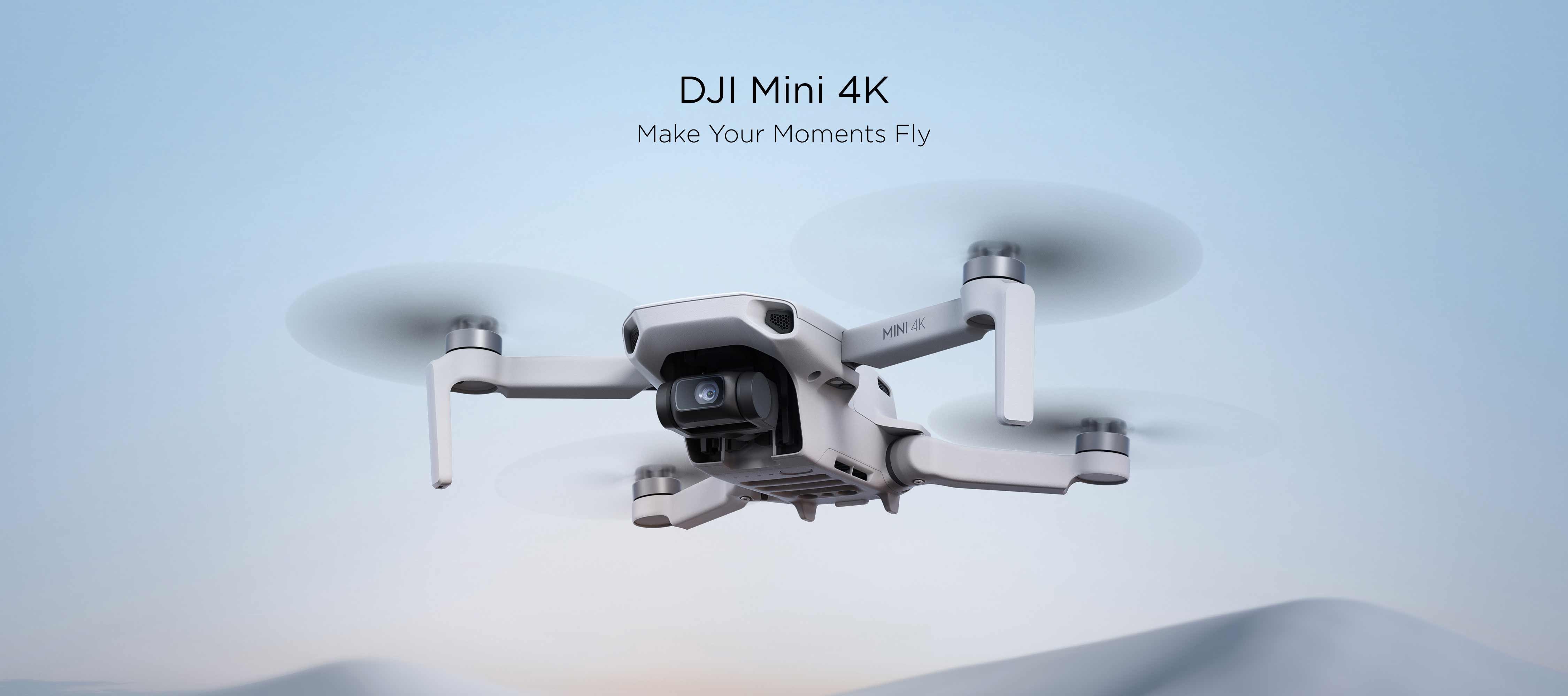 A hovering DJI Mini 4K against a blue background.