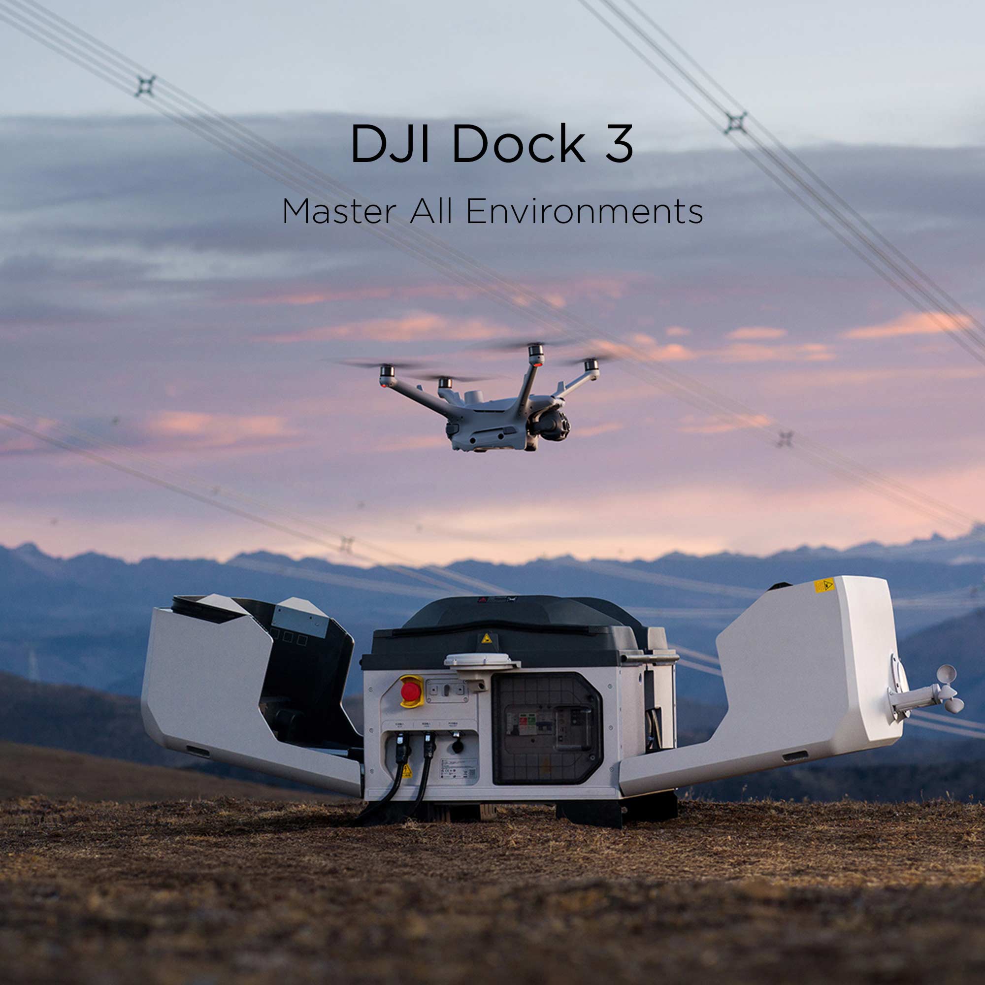 A Matrice 4TD hovers above the DJI Dock 3 sitting a field with mountains and powerlines in the background.